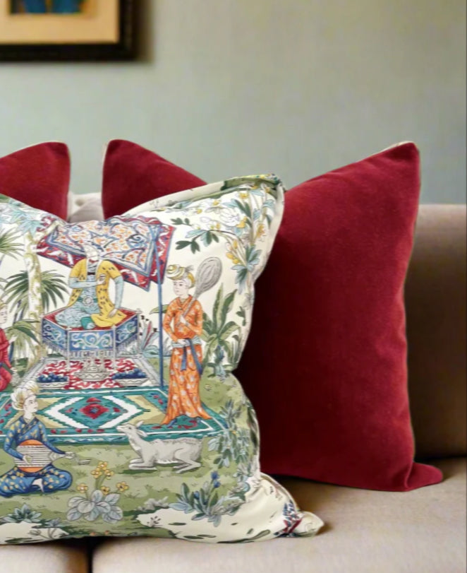 Decorative pillows on a sofa with a floral and oriental design.