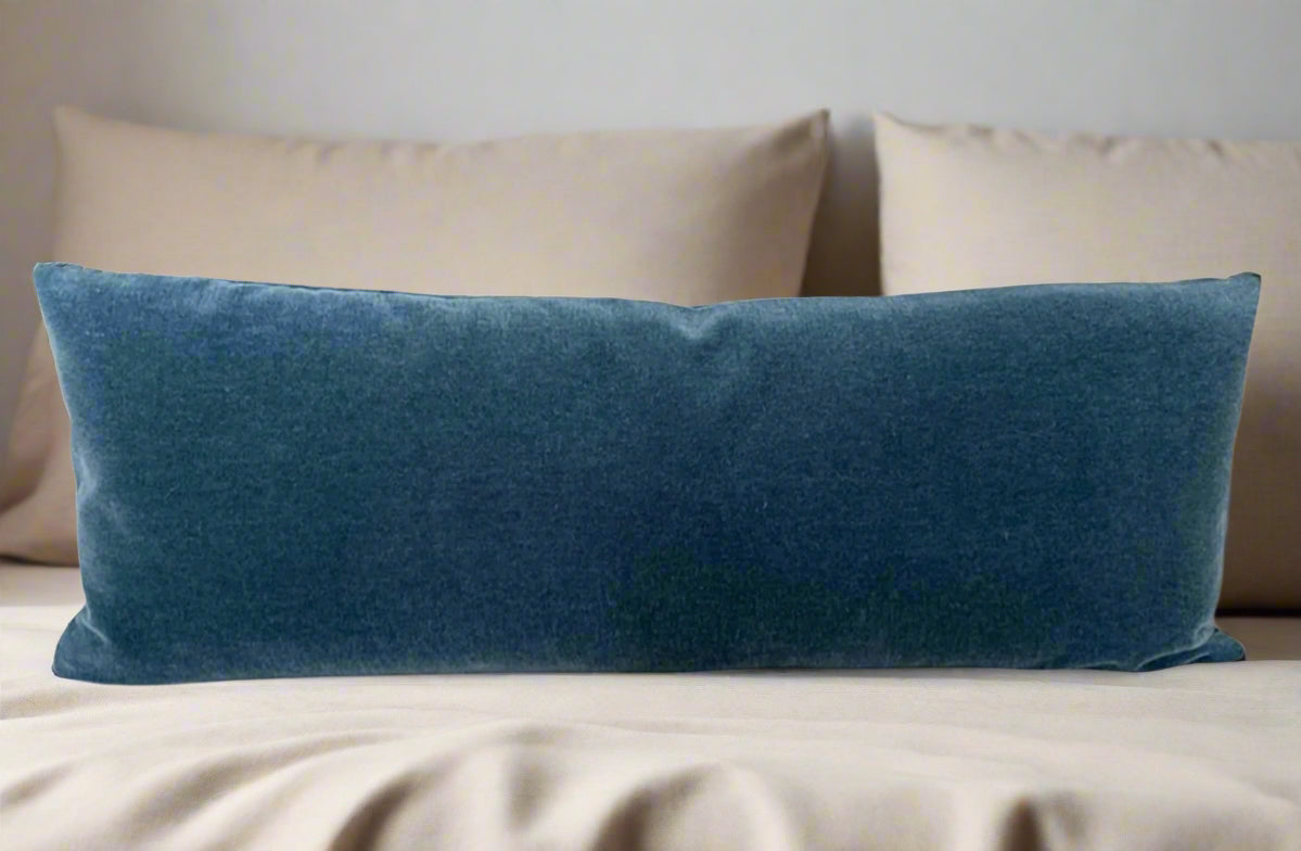 Blue pillow on a beige bed
