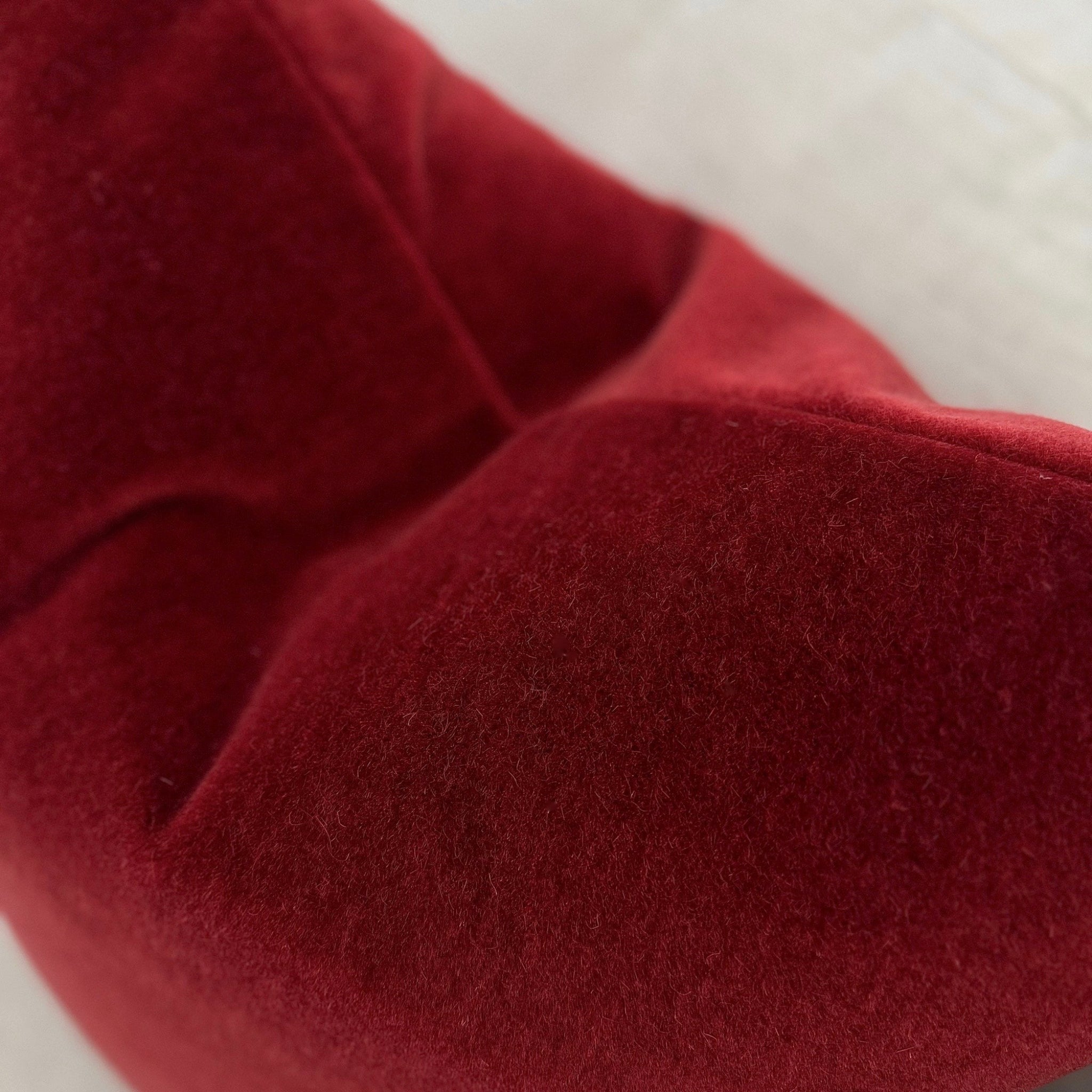 Close-up of a red fabric surface with a textured pattern