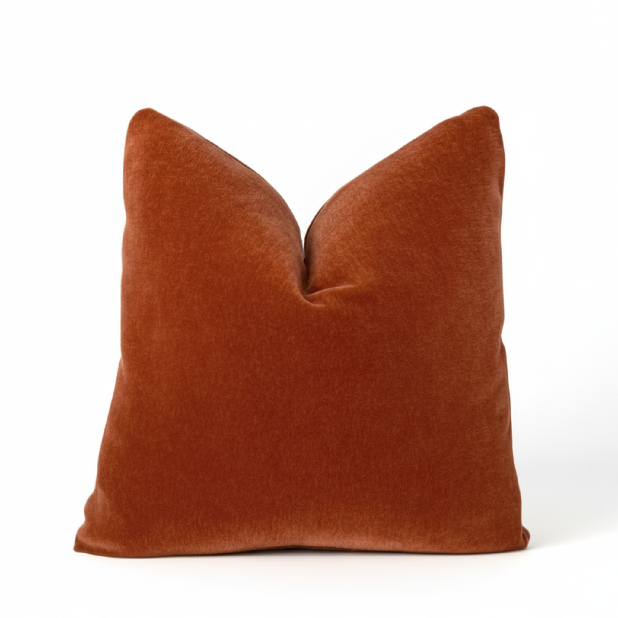 burnt orange pillow on a white background