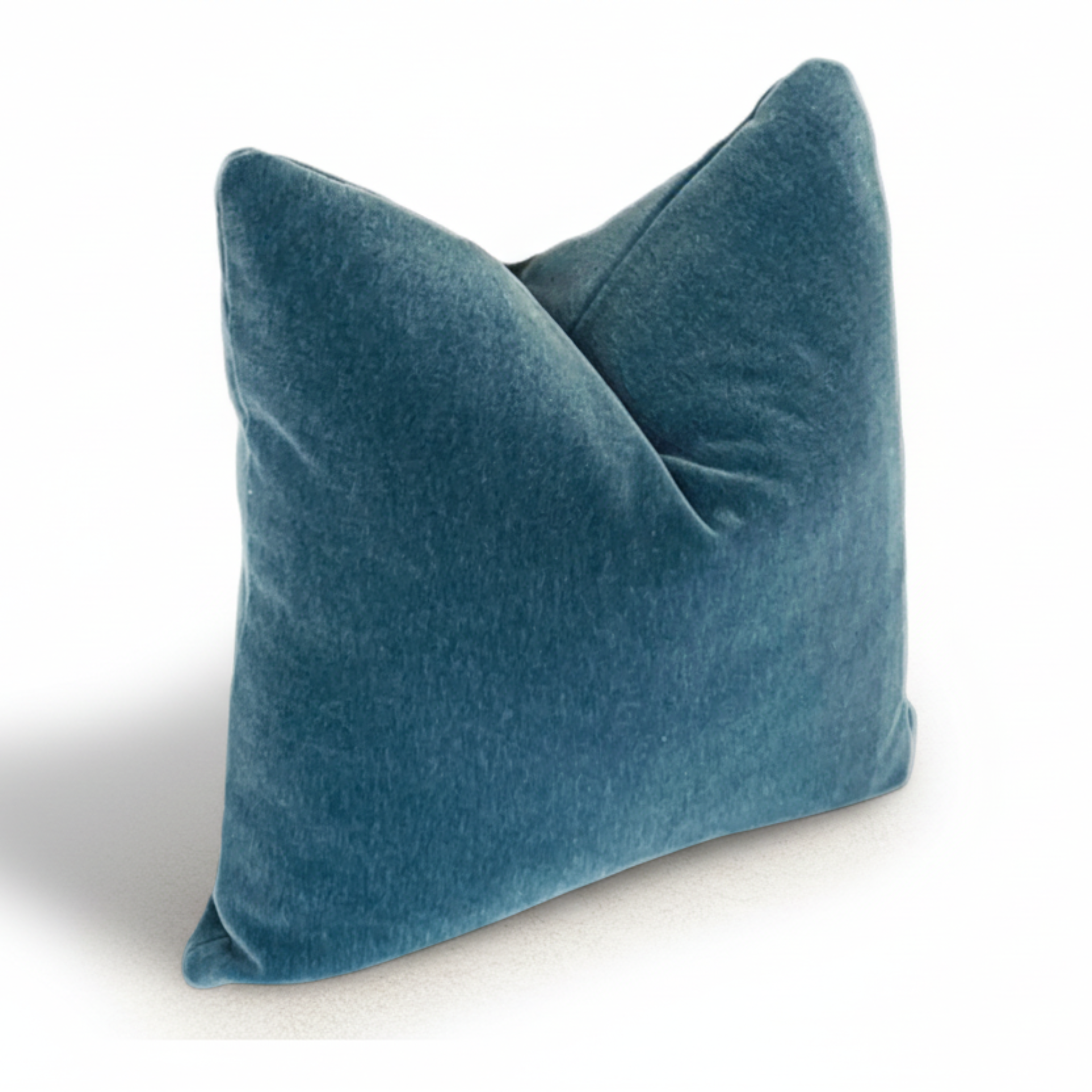 Teal velvet pillow on a white background